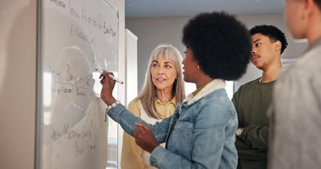 Tutor explaining maths on a whiteboard